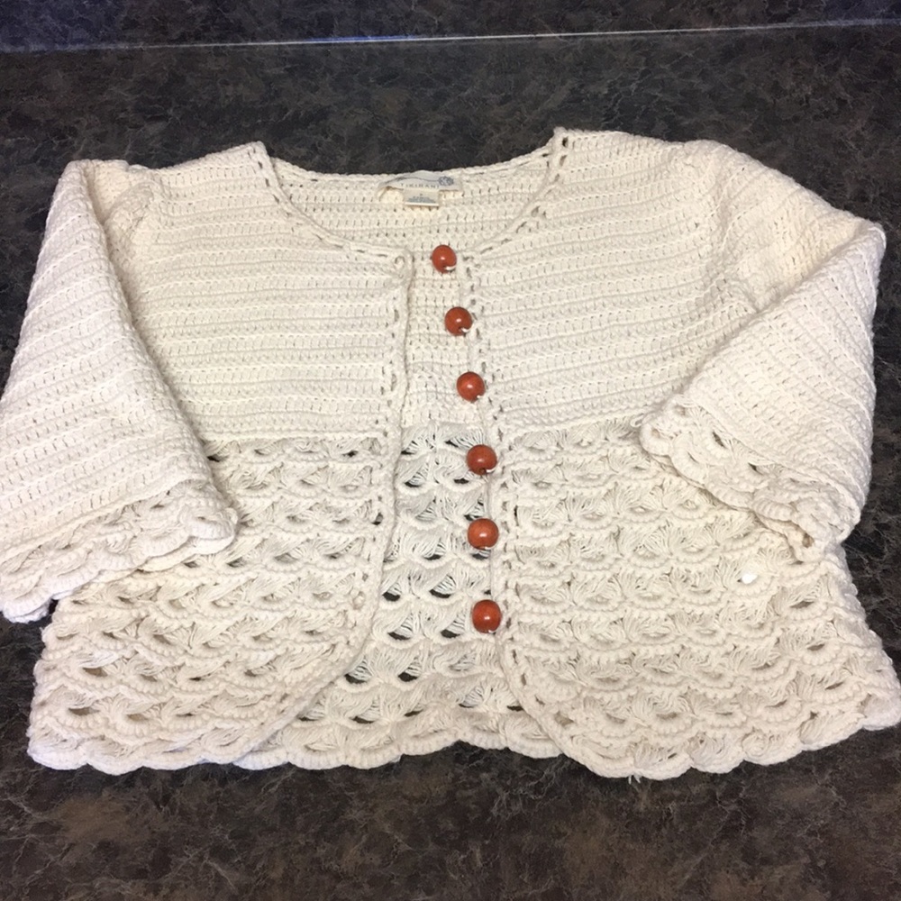 Beautifully knitted sweater with wood buttons.